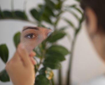 portrait-young-woman-with-low-self-esteem-looking-hand-held-mirror